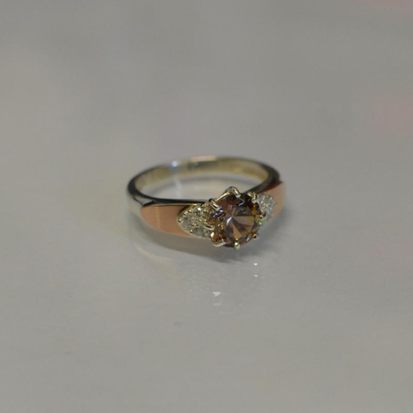 Срібна каблучка з золотими вставками