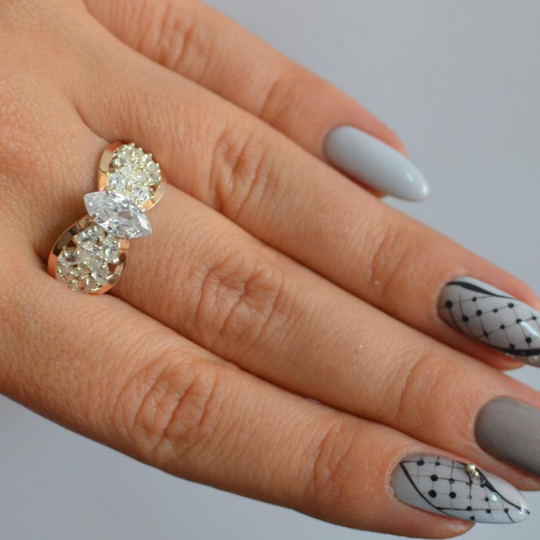 Срібна каблучка з золотими вставками